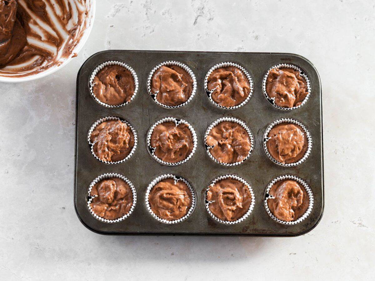 Chocolate sourdough cupcake batter in cupcake liners.