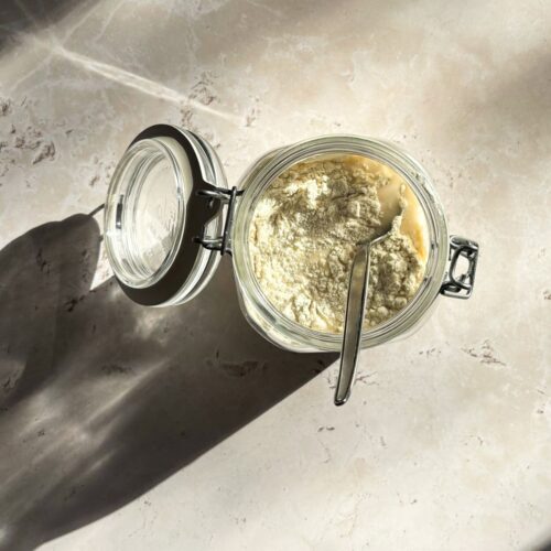 A glass jar with a spoon.