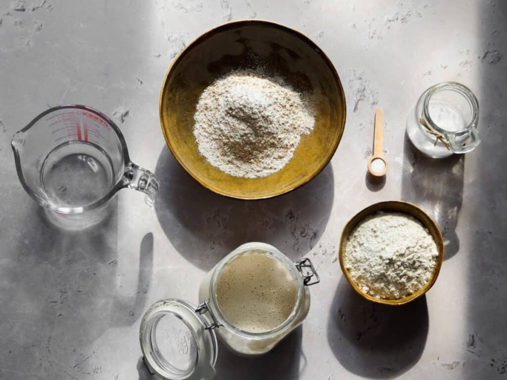 All the ingredients to make 100% whole wheat sourdough bread.