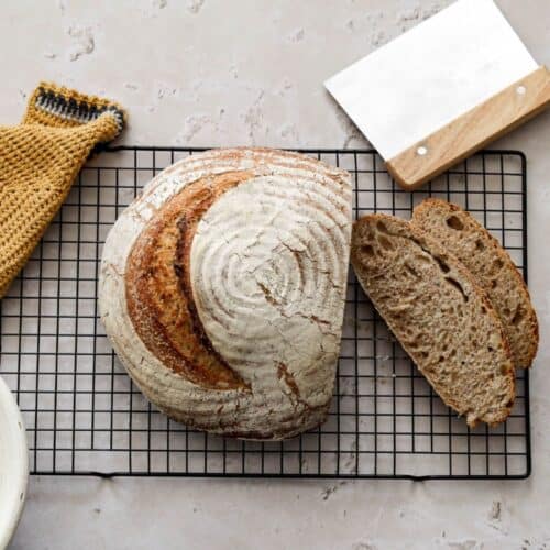 Sourdough whole wheat bread with slices.