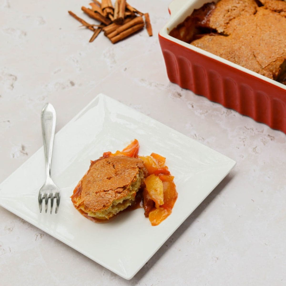 A plate with sourdough peach cobbler.