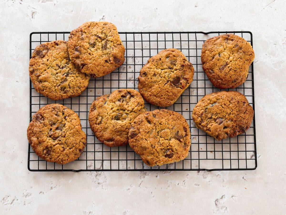 Sourdough chocolate chip cookies on a cooling rack.