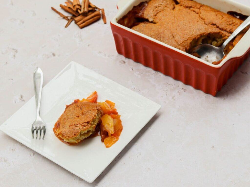 Sourdough peach cobbler on a white plate.