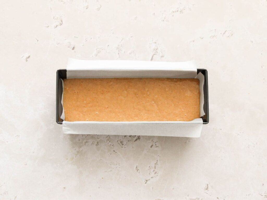 Batter for sourdough pumpkin bread in a loaf tin.