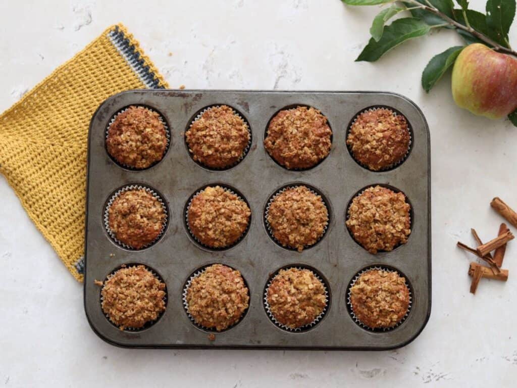 Twelve sourdough muffins with apple and oatmeal.