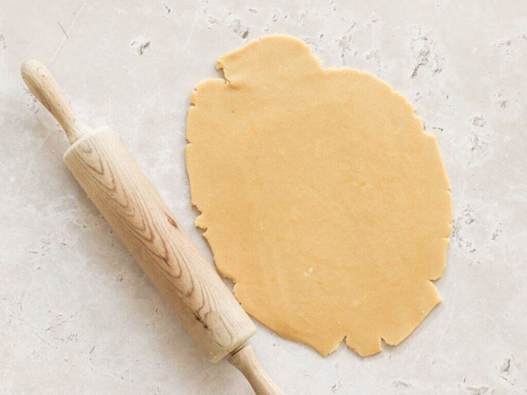 Homemade pie crust rolled out with a rolling pin.