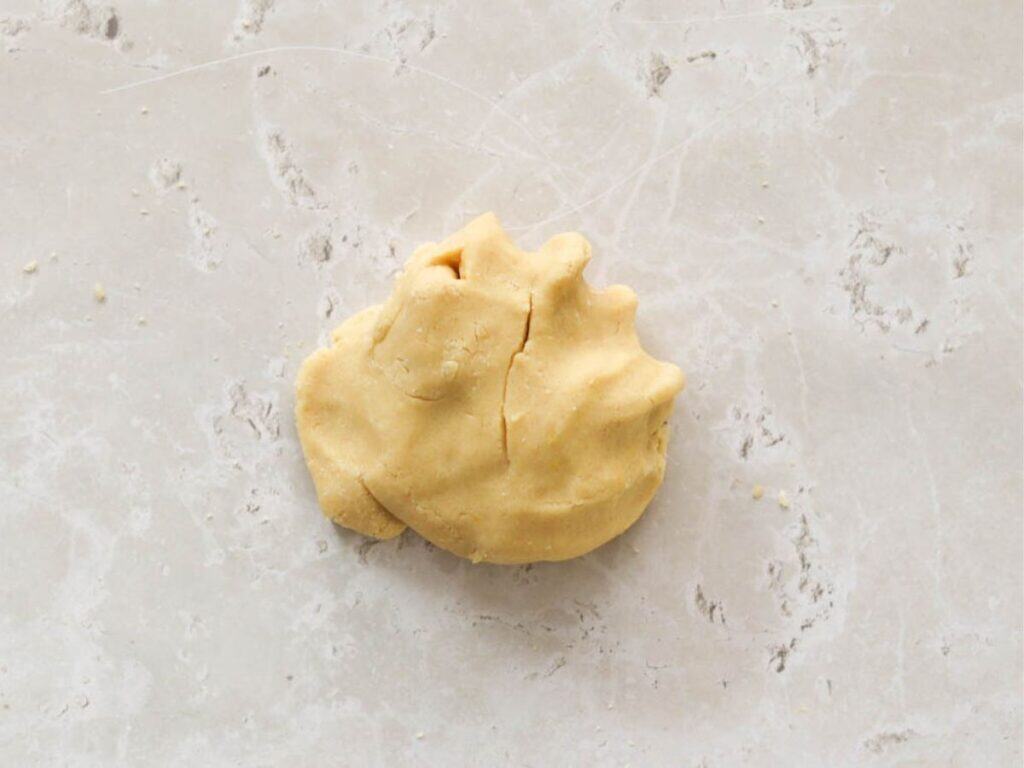 Homemade pie crust ready to be wrapped in plastic wrap.