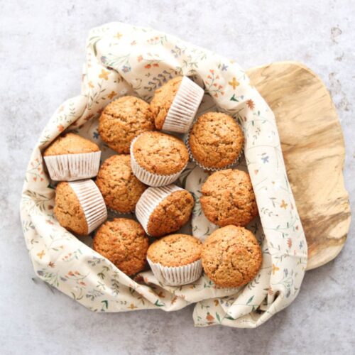 Whole wheat sourdough discard muffins in a basket.