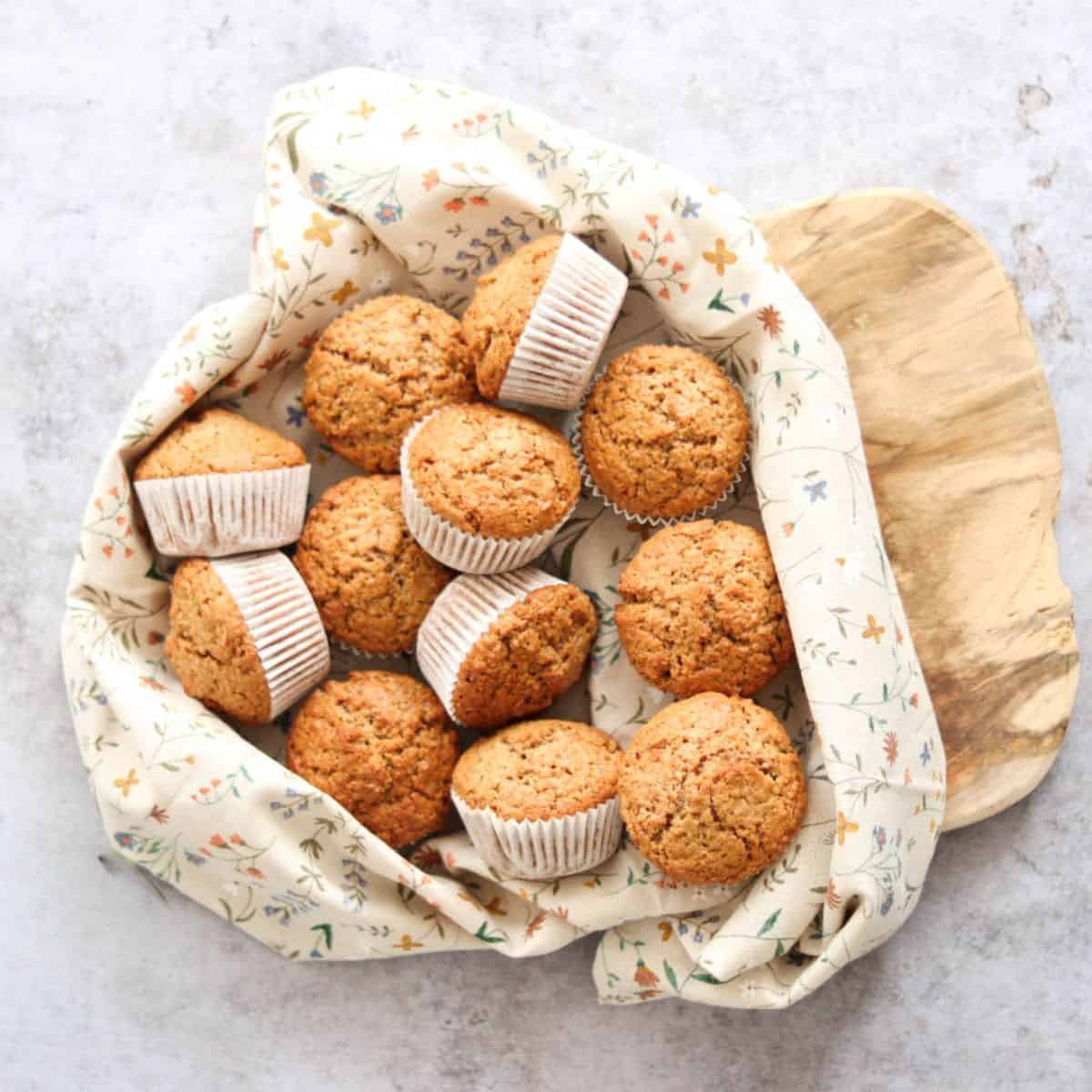 Whole wheat sourdough discard muffins in a basket.