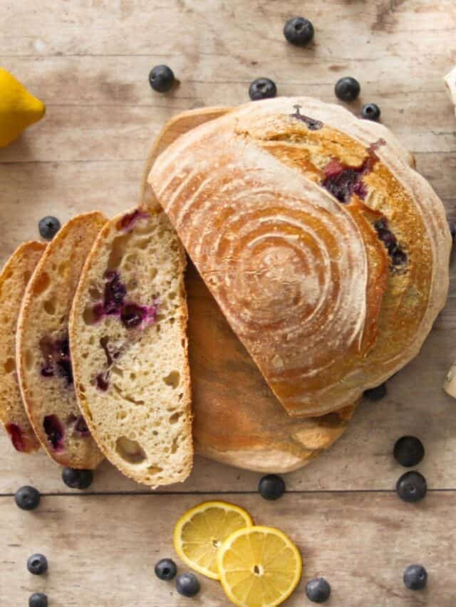 Blueberry lemon sourdough bread with a towel.