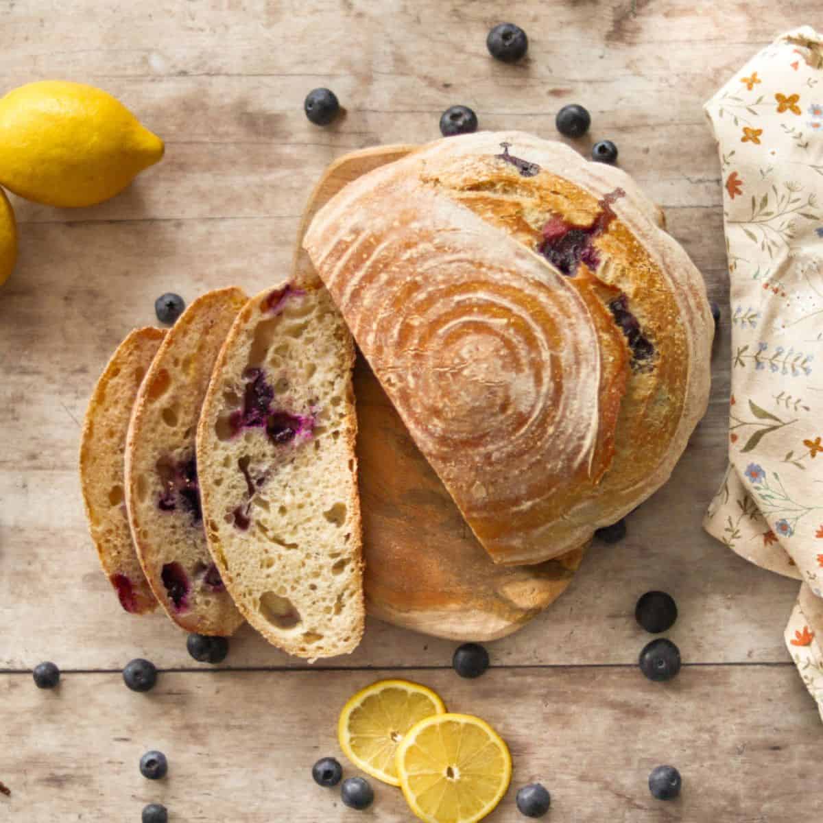 Blueberry lemon sourdough bread with a towel.