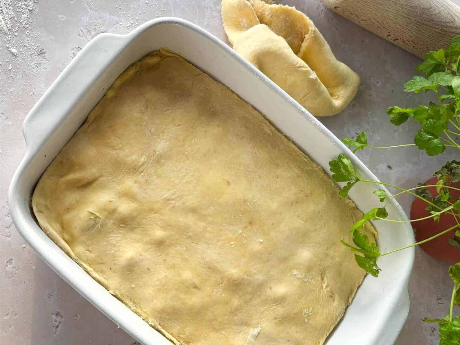 Sourdough chicken pot pie in a white oven dish ready for the oven.