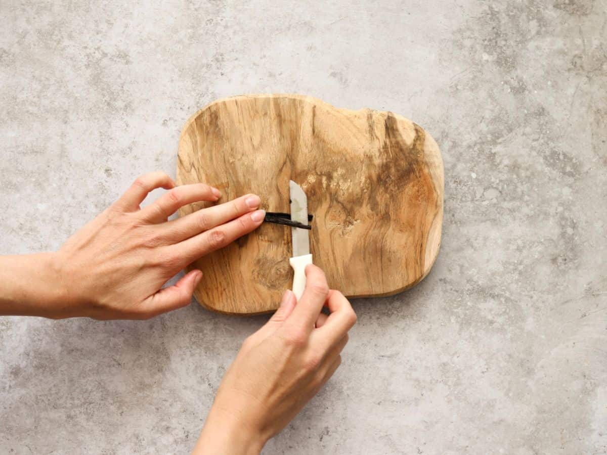 Cutting a vanilla bean in half.