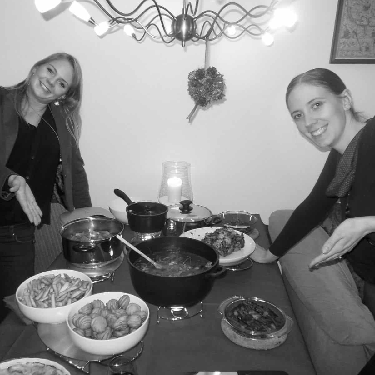 Maayke and Kim next to a Christmas dinner they made.