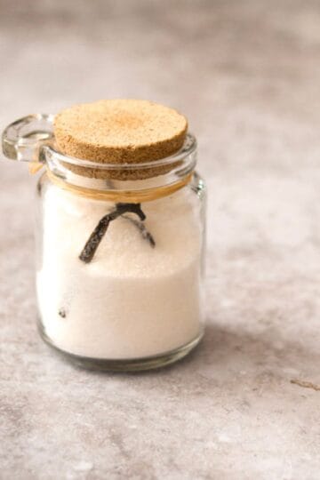 Homemade vanilla sugar in a glass jar.