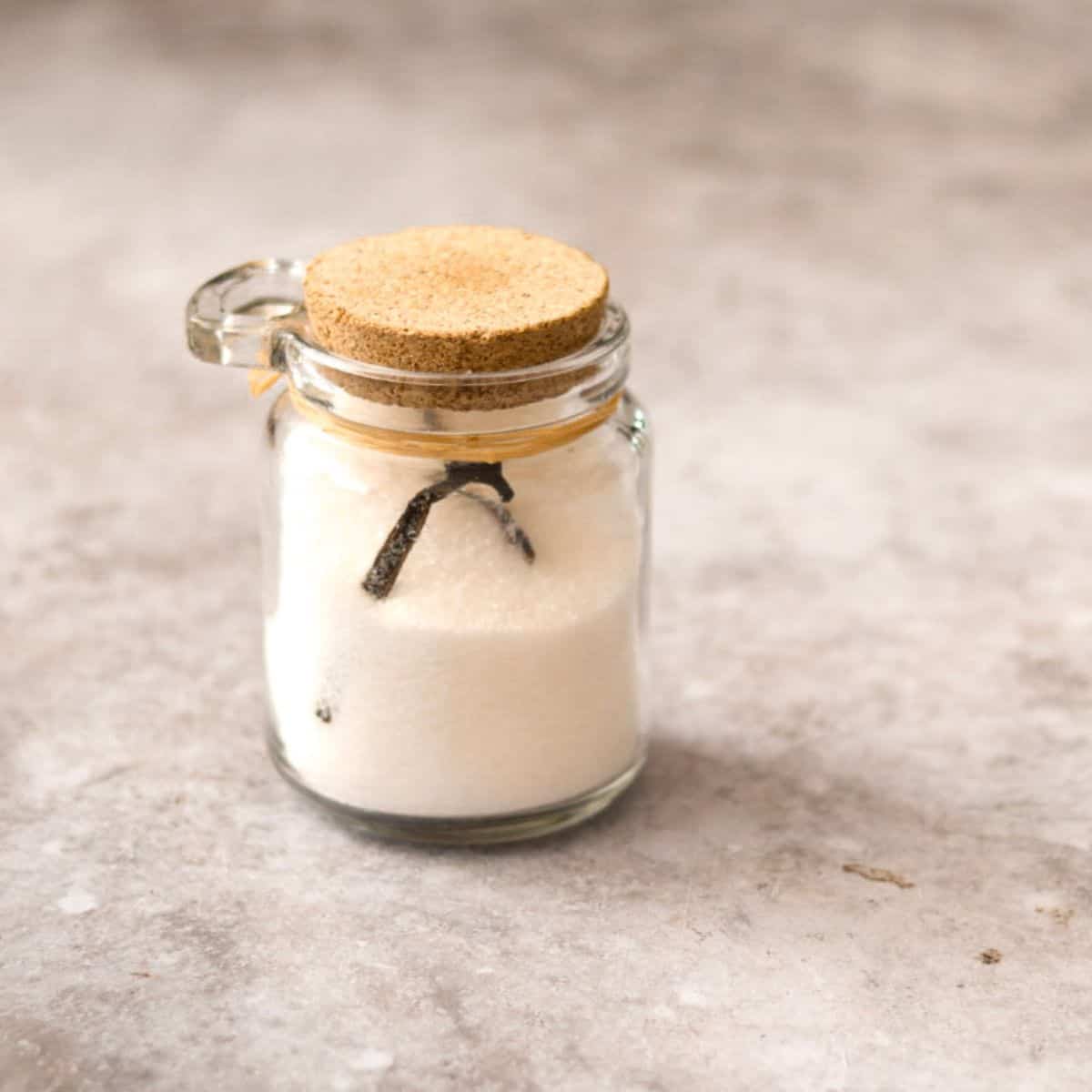 Homemade vanilla sugar in a glass jar.