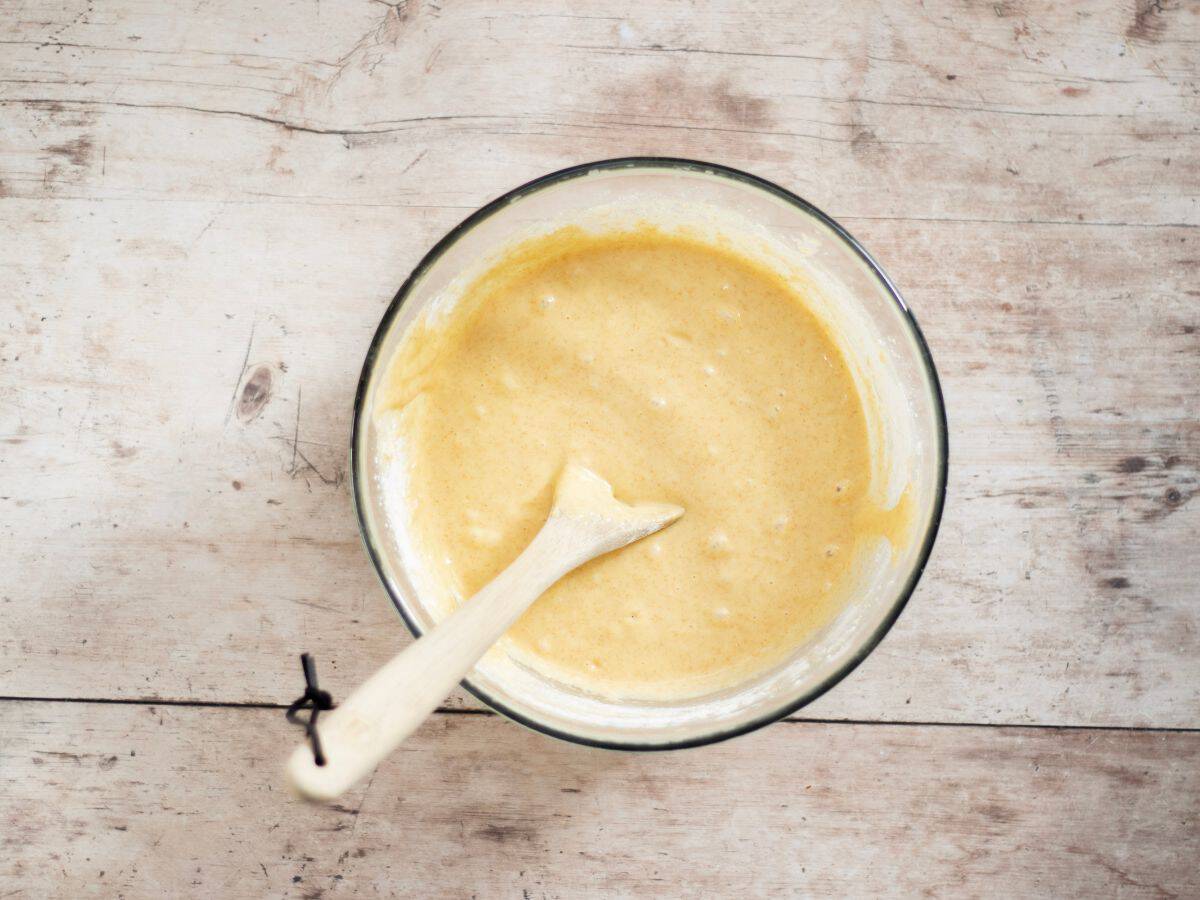 Gluten-free-sourdough muffin batter in a glass bowl.