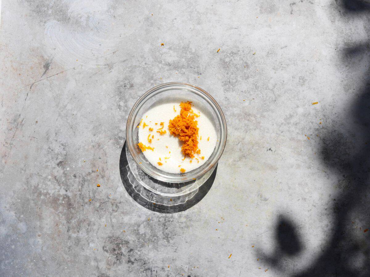 Adding the orange zest to the granulated sugar.