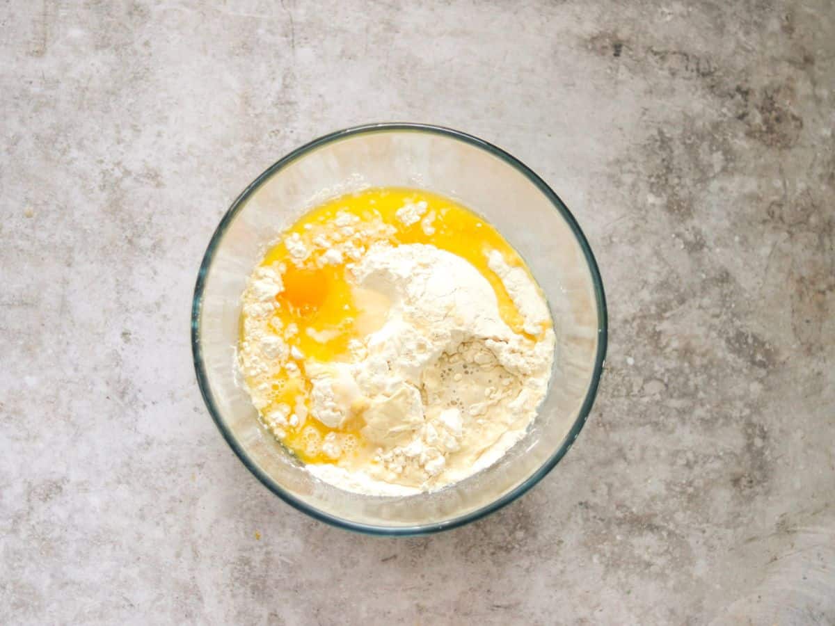 Mixing the ingredients for hot dog buns with sourdough starter.