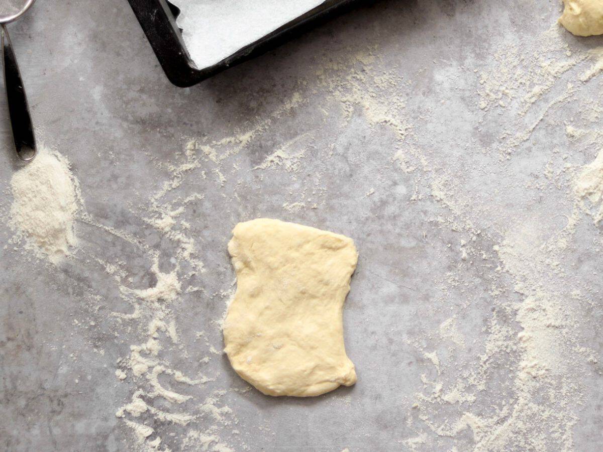 Shaping hot dog sourdough buns.