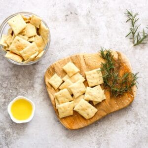 A bowl of sourdough crackers made with rosemary and discard.