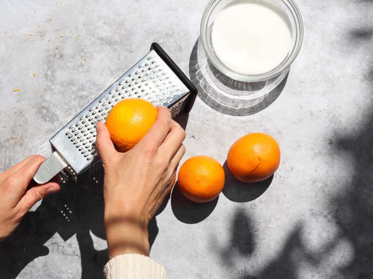 Zesting an orange to make orange infused sugar.