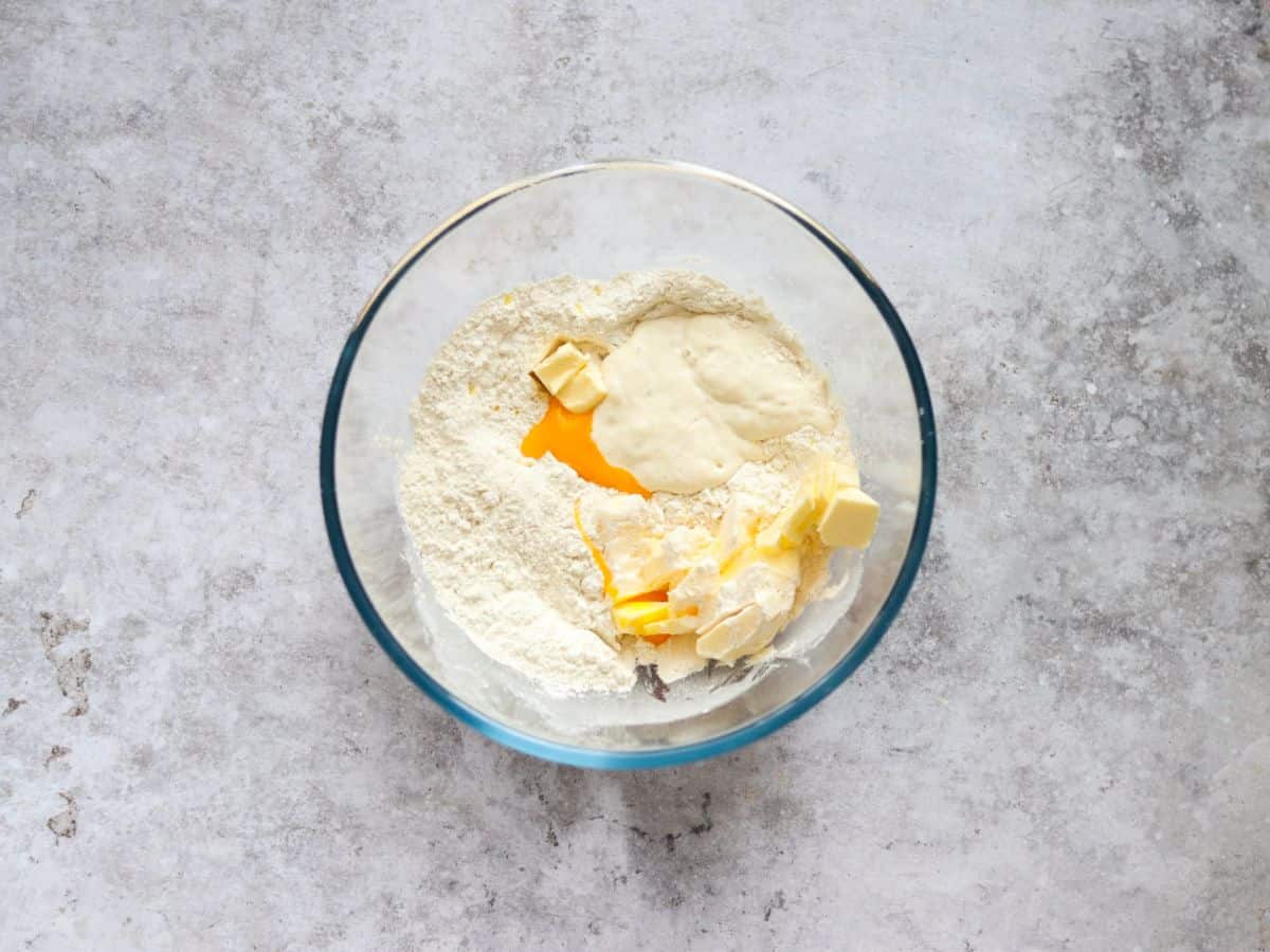 Adding the ingredients for discard pie crust to a glass bowl.